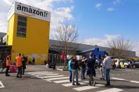 Amazon employees on strike gather outside the Amazon distribution center warehouse in Saran