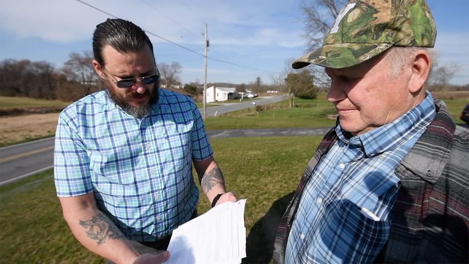 Kevin Zygmunt, left, and Glenn Forry look over paperwork they have collected while trying to address trucks ignoring the 30-foot length restriction signs on Locust Point Road in Conewago Township.