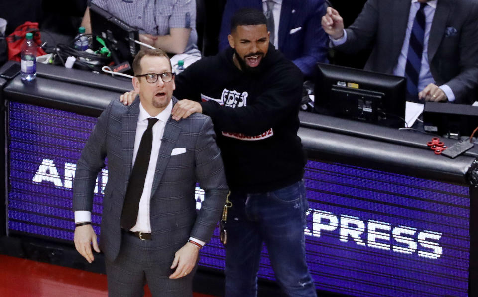 TORONTO, ON- MAY 21  - Drake massages Toronto Raptors head coach Nick Nurse's shoulder as the  Toronto Raptors beat the Milwaukee Bucks in game four 120-102 to even up the Eastern Conference NBA Final at two games each  at Scotiabank Arena in Toronto. May 21, 2019.        (Steve Russell/Toronto Star via Getty Images)