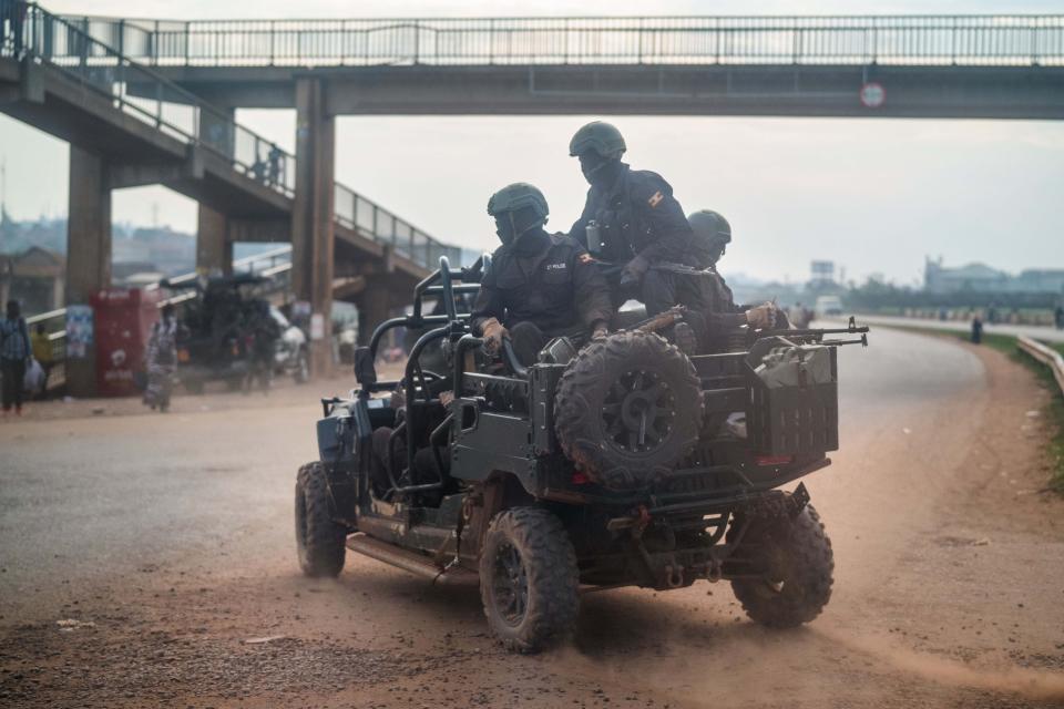 Security forces patrol the streets of Kampala, Uganda, Thursday, Jan. 14, 2021.Ugandans are voting in a presidential election tainted by widespread violence that some fear could escalate as security forces try to stop supporters of leading opposition challenger Bobi Wine from monitoring polling stations. (AP Photo/Jerome Delay)