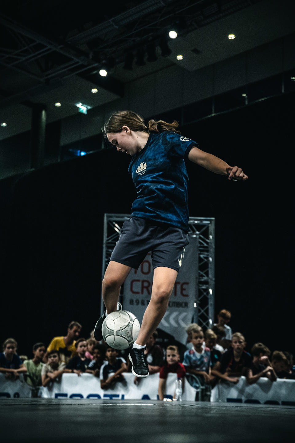 Girl with ball between her feet