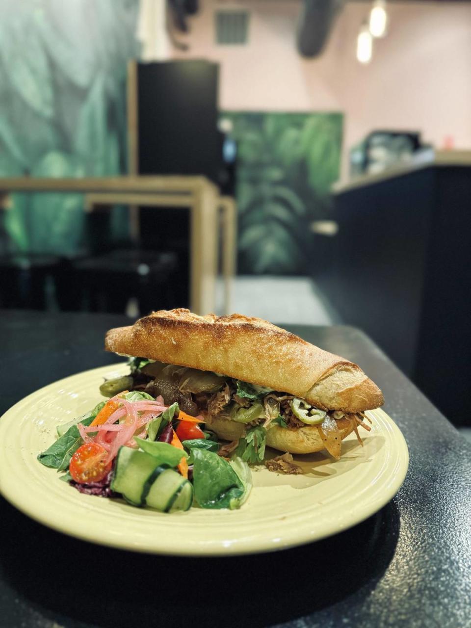 The Caribbean pork sandwich will come with marinated and slow roasted pork, caramelized onion, pickled jalapenos, romaine lettuce, cilantro and a tangy garlic aioli, served on a toasted demi baguette that’s fresh-baked daily. It’s pictured with a mixed greens salad.