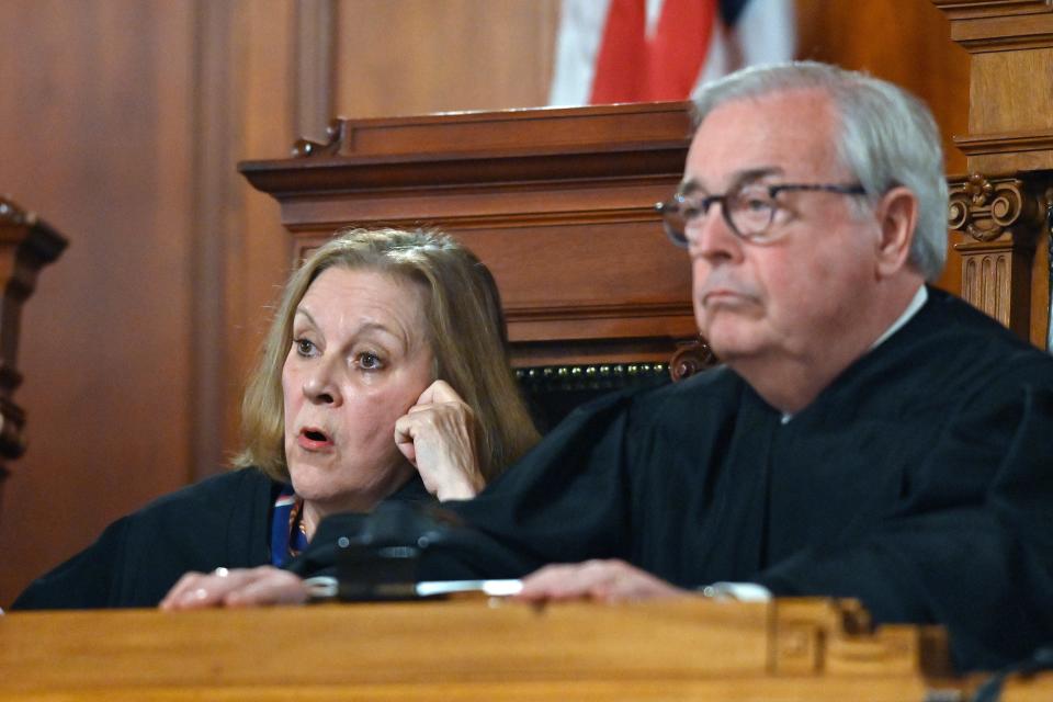 Kentucky Supreme Court Justice Lisabeth Hughes, left, asks a question as Kentucky Supreme Court Chief Justice John D. Minton Jr. listens during arguments before the court whether to temporarily pause the state's abortion ban in Frankfort, Ky., Tuesday, Nov. 15, 2022. (AP Photo/Timothy D. Easley)