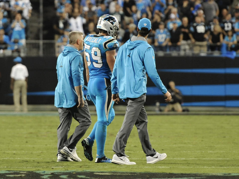 Carolina Panthers’ Luke Kuechly (59) is helped off the field after being injured in the first half of an NFL football game against the Philadelphia Eagles in Charlotte, N.C., Thursday, Oct. 12, 2017. (AP Photo/Mike McCarn)