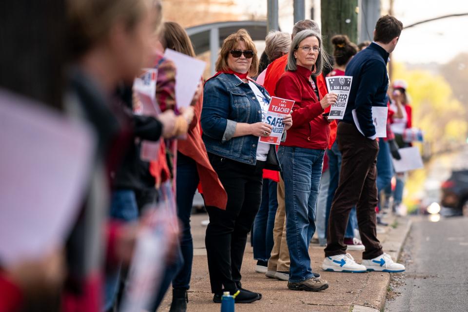 Participants gather on 21st Ave. S during the Linking Arms for Change human chain in Nashville, Tenn., Wednesday, March 27, 2024. The event was held to honor the one year anniversary Covenant School shooting.