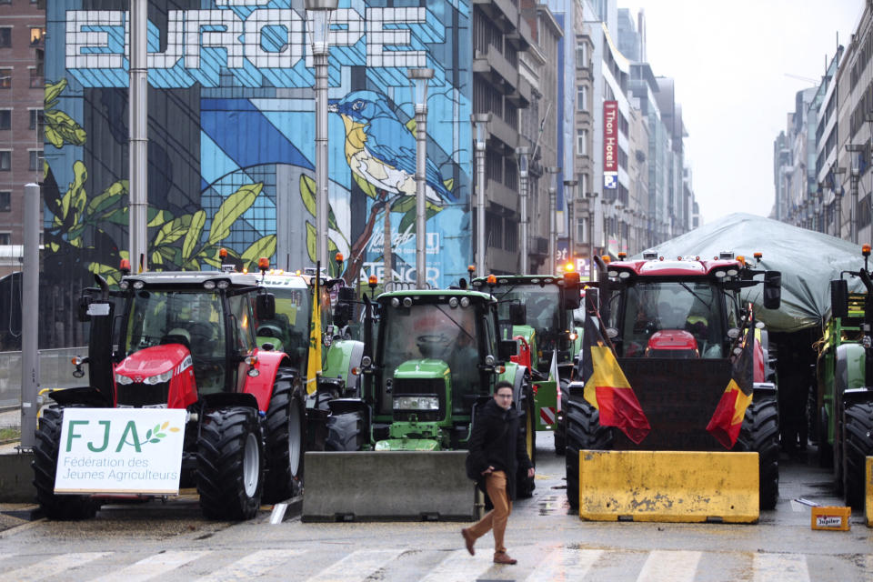 FILE - Tractors are parked behind a blockade in the European Quarter during a protest of farmers outside a meeting of EU agriculture ministers in Brussels, Monday, Feb. 26, 2024. The European Union's executive arm on Friday, March 15, 2024 proposed to sacrifice even more climate and environmental measures in the bloc's latest set of concessions to farmers who appear bent to continue their disruptive tractor protests until the June EU elections. (AP Photo/Nicolas Landemard, File)