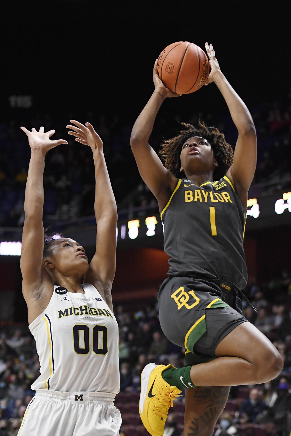 Baylor's NaLyssa Smith (1) shoots over Michigan's Naz Hillmon (0) in the first half of an NCAA college basketball game, Sunday, Dec. 19, 2021, in Uncasville, Conn. (AP Photo/Jessica Hill)