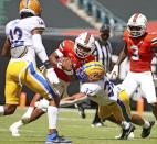 Miami quarterback D'Eriq King (1) is tackled by Pittsburgh linebacker SirVocea Dennis (32) during the first quarter of an NCAA college football game at Hard Rock Stadium in Miami Gardens, Fla., Saturday, Oct. 17, 2020. (Al Diaz/Miami Herald via AP)