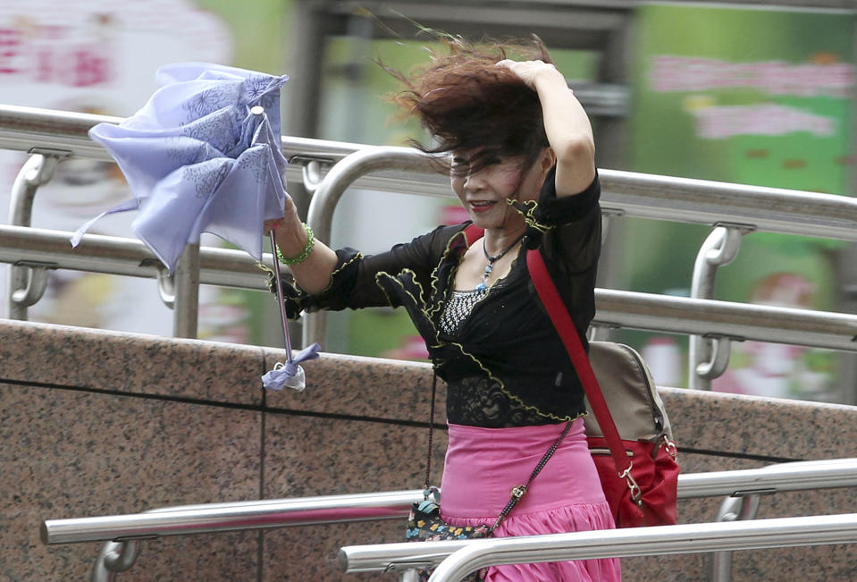 A woman struggles in the wind