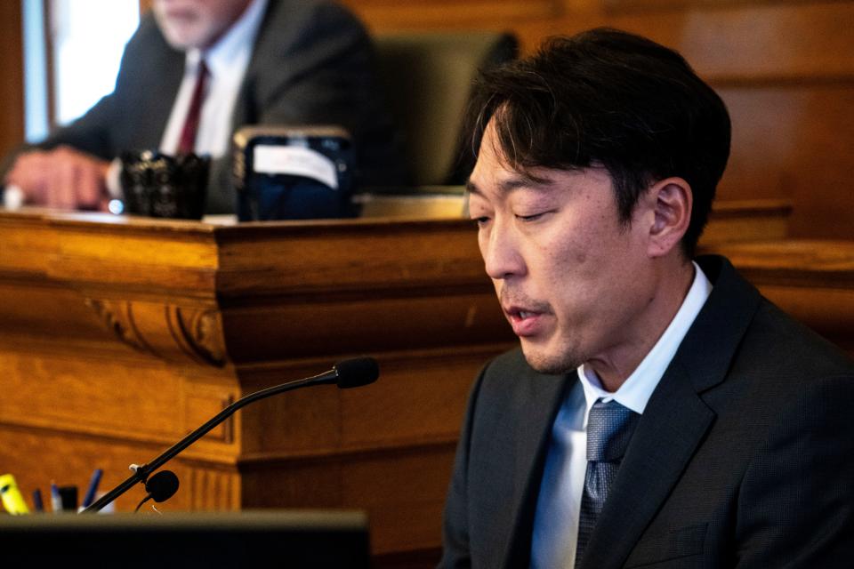 Seung Lim, Sung Woo Nam's brother-in-law, reads a victim impact statement written by An Nam, Sung's father, right, during a sentencing hearing for Gowun Park at the Dallas County Courthouse on Thursday.