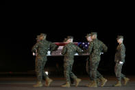 A U.S. Marine Corps carry team moves a transfer case containing the remains of Staff Sgt. Christopher A. Slutman, Thursday, April 11, 2019, at Dover Air Force Base, Del. According to the Department of Defense, Slutman, of Newark, Del., was among three American service members killed by a roadside bomb on Monday, April 8, 2019, near Bagram Airfield in Afghanistan. (AP Photo/Patrick Semansky)