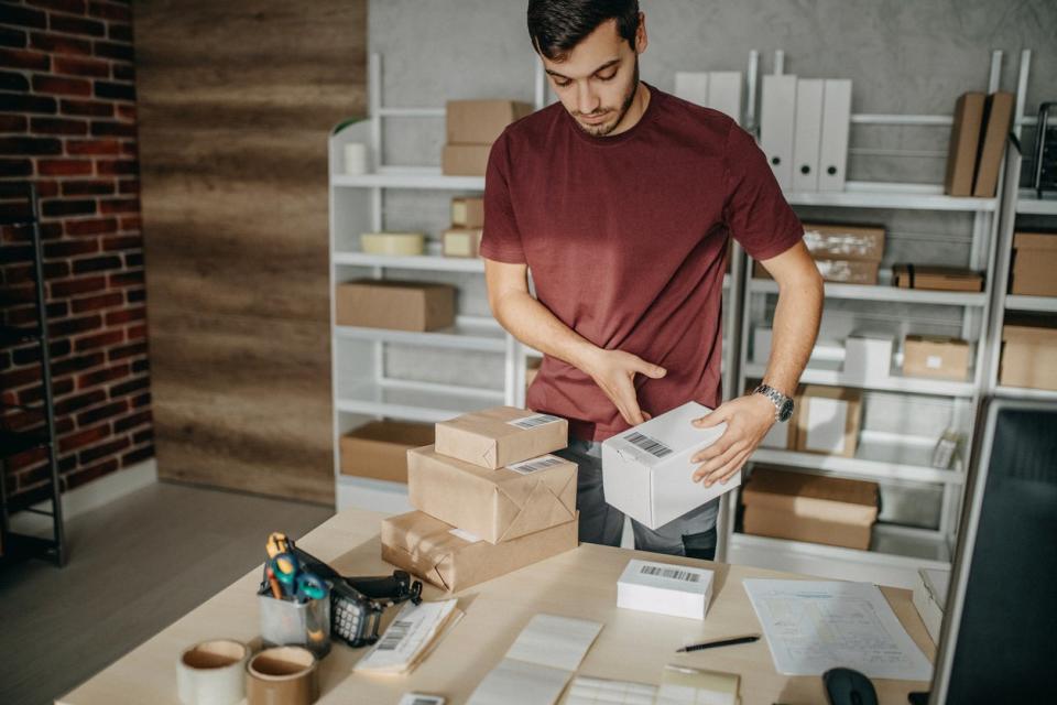 Man packing boxes from home fulfillment center in garage