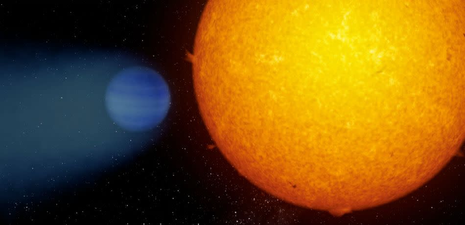 Artist’s rendition of exoplanet WASP-69b losing its atmosphere in a comet-like tail.