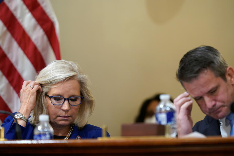 Reps. Liz Cheney and Adam Kinzinger listen during a House select committee hearing on the Jan. 6 attack. 