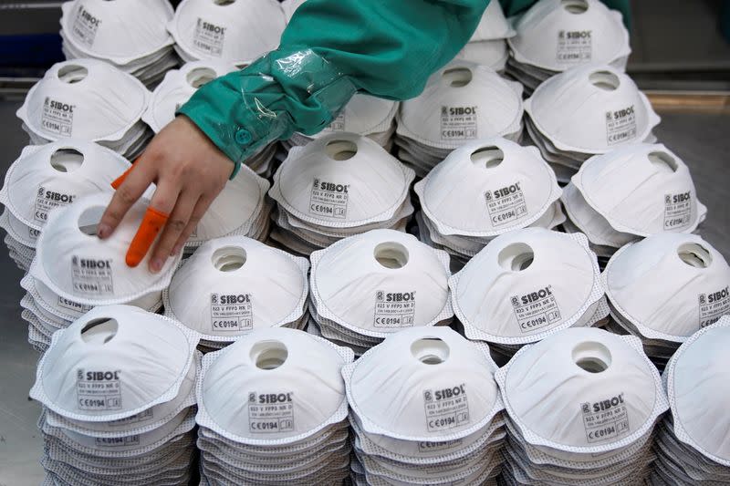 Masks are seen on a production line manufacturing masks at a factory in Shanghai