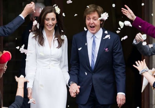 Sir Paul McCartney (R) and his new wife Nancy Shevell (L) leave Marylebone registry office in central London following their wedding. McCartney married for the third time on Sunday, tying the knot with New York heiress Shevell at the same London venue where he married his first wife