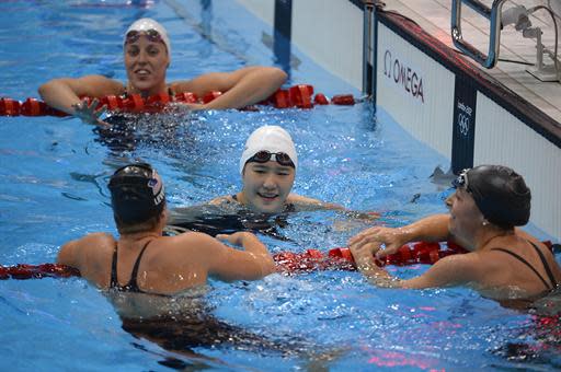 China's Ye Shiwen (C) celebrates after winning the women's 200m individual medley final during the swimming event at the London 2012 Olympic Games on July 31, 2012 in London. AFP PHOTO / ODD ANDERSEN