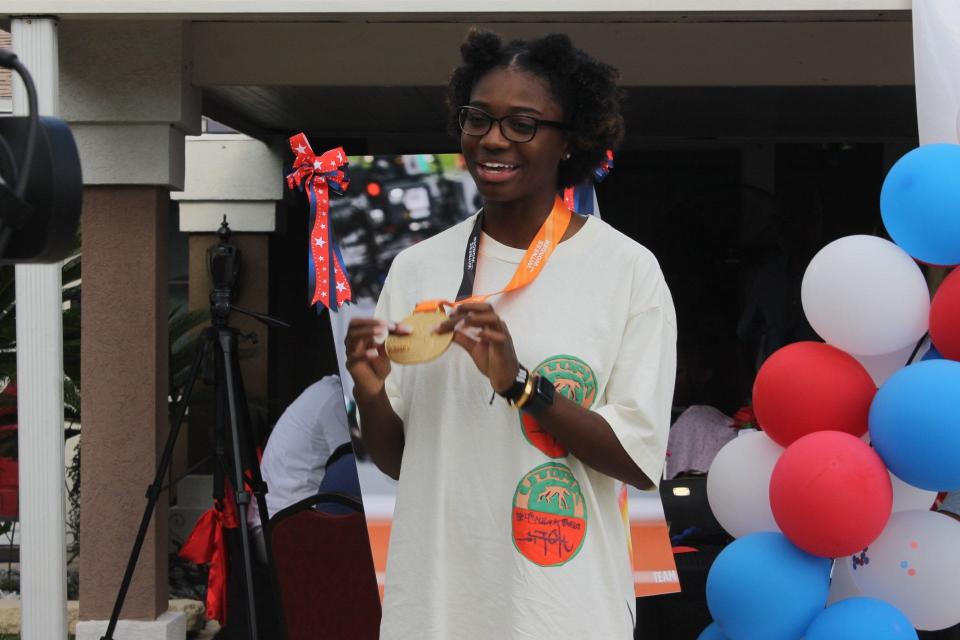 Tamari Davis holds the Gold Medal she won as the first leg of the USA's women's 4x100 relay team at the 2023 World Athletics Championships in Budapest, Hungary last month. Davis, an East Gainesville native, was the guest of honor at an event held Saturday.
(Credit: Photo by Voleer Thomas/For The Guardian)