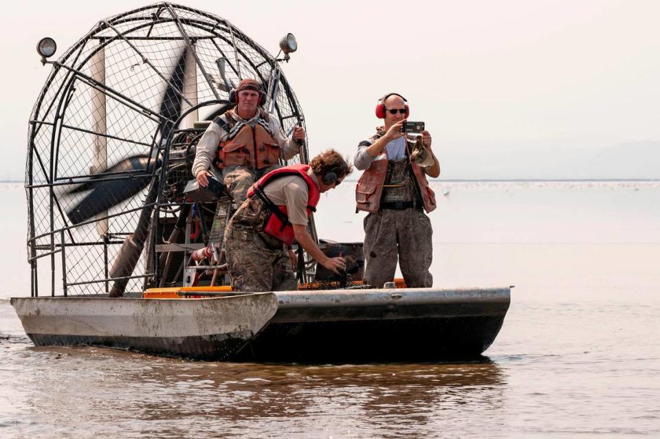 Sacramento Bee reporter Ryan Sabalow, right, collects footage from an airboat on Tule Lake National Wildlife Refuge in Northern California’s Siskiyou County on Sept. 4, 2020, for part of his series on the region’s ecological crisis.