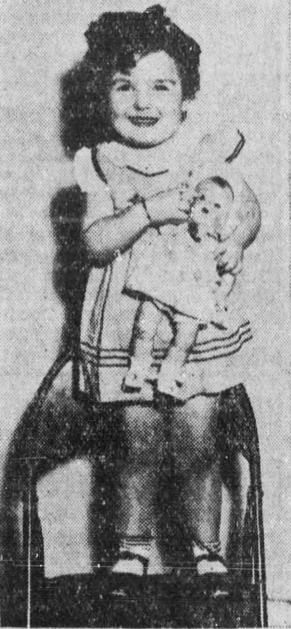 Dorothy Ann Pailliotet, 3, holds a baby doll that she won in an Akron contest in 1936.