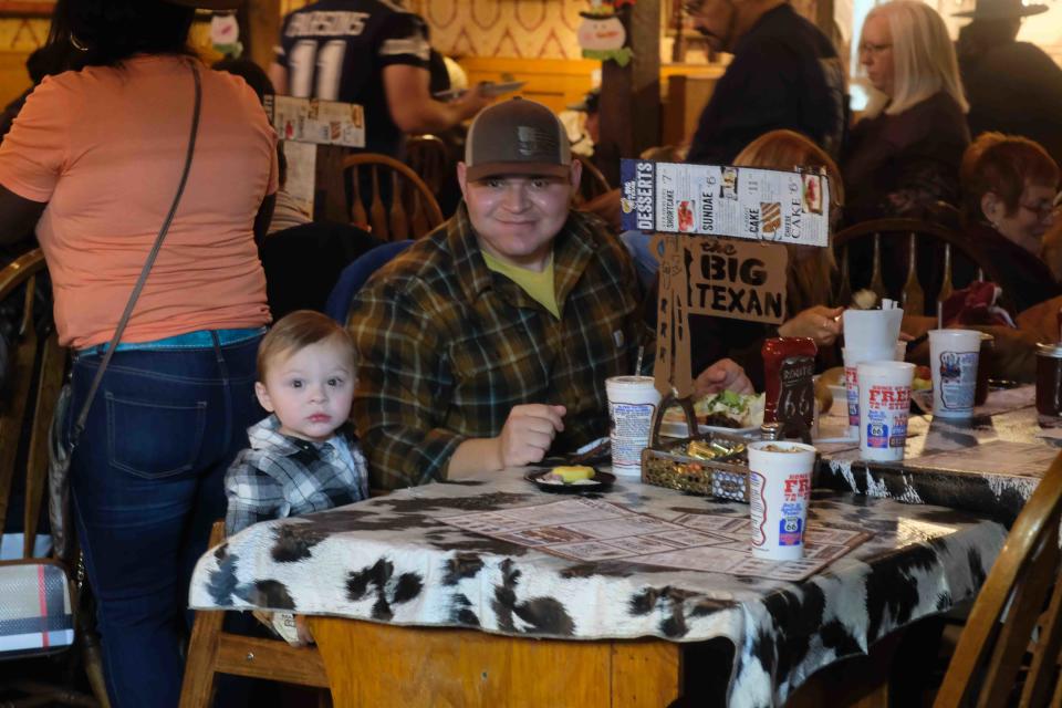 A young patron enjoys his holiday meal Thursday at the Big Texan in East Amarillo