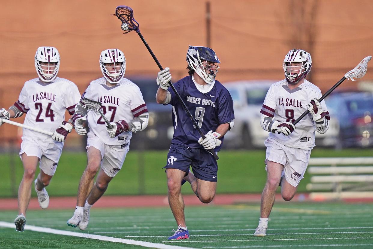 Moses Brown's Liam Gray races upfield while being pursued by three La Salle defenders during the first quarter on Tuesday night.