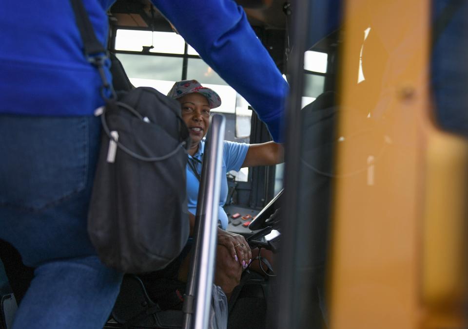 School bus driver Alfreda Newton watches over the students boarding her bus in the Martin County High School bus loop on Thursday, Oct. 19, 2023, in Stuart. "I love taking care of kids and making sure they're safe and get back and forth to school," Newton said.