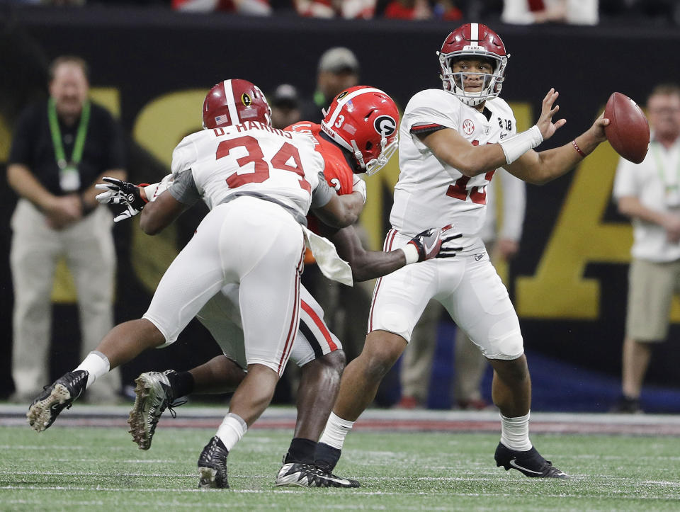 File- This Jan. 8, 2018, file photo shows Alabama quarterback Tua Tagovailoa dropping back to pass during the second half of the NCAA college football playoff championship game against Georgia in Atlanta. Tagovailoa is fighting for the starting job at Alabama after leading the Crimson Tide to a second-half comeback in last year’s national championship game. The strong-armed lefty threw for 166 yards and three touchdowns in the win over Clemson. (AP Photo/David J. Phillip, File)