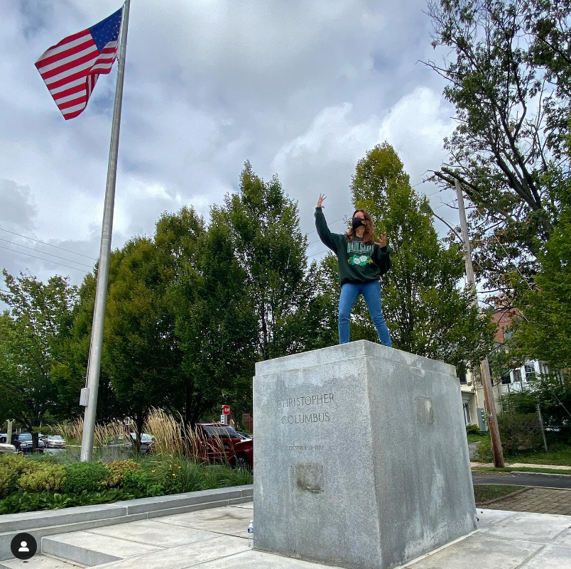 Aubrey Plaza stands where a Christopher Columbus statue once stood in a photograph she posted to Instagram in 2021. The spot has been unofficially renamed The Aubrey Plaza Plaza and has fans worldwide through a cheeky Facebook page run by Wilmington's Pete Romano.