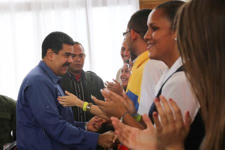 Venezuela's President Nicolas Maduro (L) greets supporters as he arrives for an event in Caracas, Venezuela July 20, 2017. Miraflores Palace/Handout via REUTERS