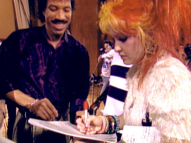 Lionel Richie and Cyndi Lauper work out a lyric in "We Are the World." A documentary on the 1985 recording session — "The Greatest Night in Pop" — lands on Netflix Jan. 29, 2024.