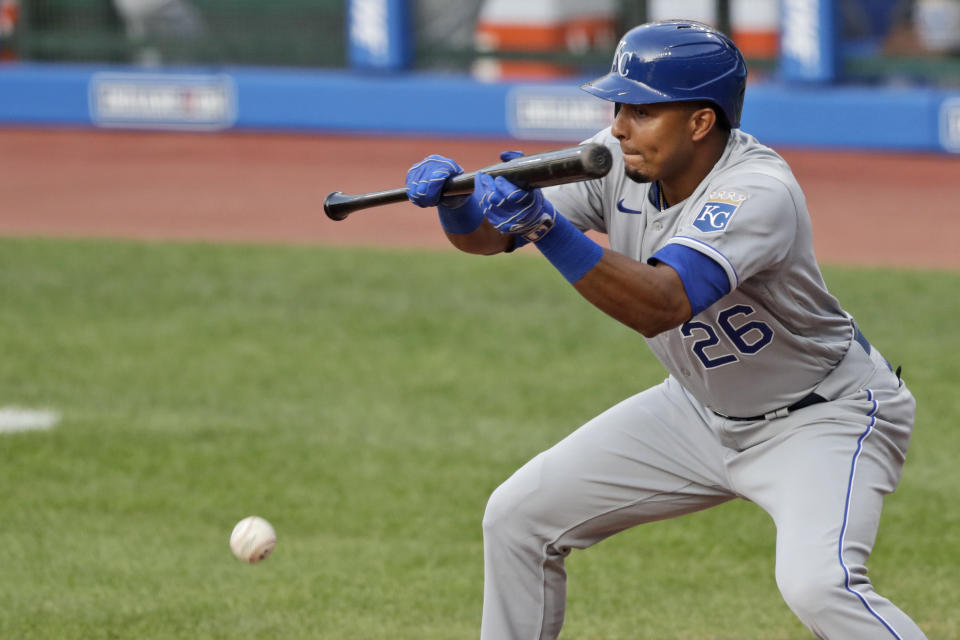 Kansas City Royals' Erick Mejia hits a sacrifice bunt in the 10th inning in a baseball game against the Cleveland Indians, Saturday, July 25, 2020, in Cleveland. Royals' Brett Phillips advanced to third base on the play. (AP Photo/Tony Dejak)