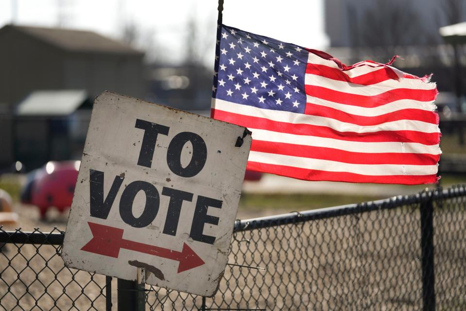 A vote sign and American flag are shown outside a Michigan primary election location in Dearborn, Mich., Tuesday, Feb. 27, 2024. Michigan is the last major primary state before Super Tuesday and a critical swing state in November's general election. (AP Photo/Paul Sancya)