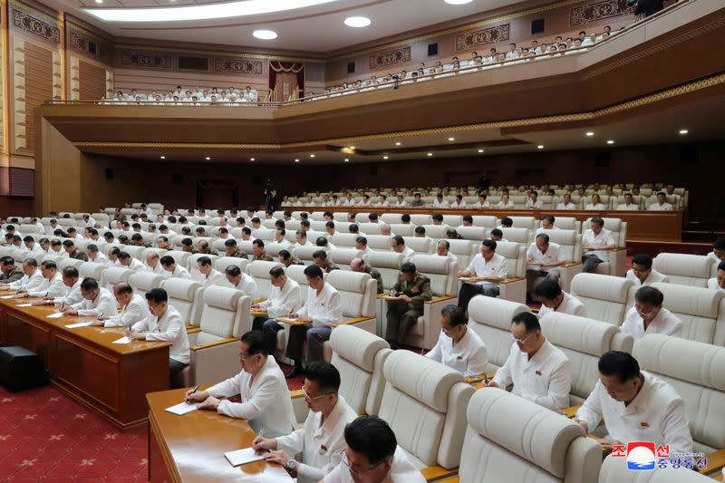 Members of the Central Committee attend a plenary meeting of the Central Committee of the Workers' Party of Korea with North Korean leader Kim Jong Un, in North Korea