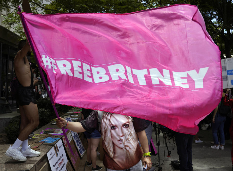 A Britney Spears supporter waves a "Free Britney" flag outside a court hearing concerning the pop singer's conservatorship at the Stanley Mosk Courthouse, Wednesday, June 23, 2021, in Los Angeles. (AP Photo/Chris Pizzello)