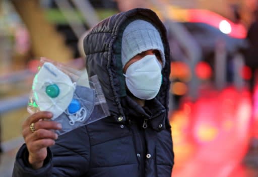 An Iranian street vendor sells protective masks in the capital Tehran