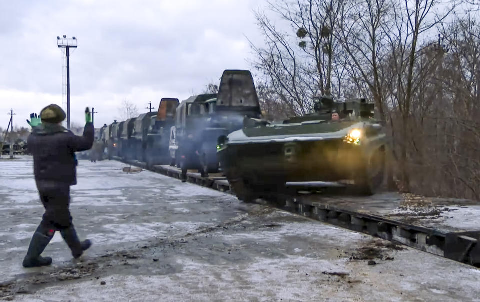 FILE - In this photo taken from video provided by the Russian Defense Ministry Press Service, a Russian armored vehicle drives off a railway platform after arrival in Belarus, Wednesday, Jan. 19, 2022. A buildup of an estimated 100,000 Russian troops near Ukraine has fueled Western fears of an invasion, but Moscow has denied having plans to launch an attack while demanding security guarantees from the the U.S. and its allies. (Russian Defense Ministry Press Service via AP, File)