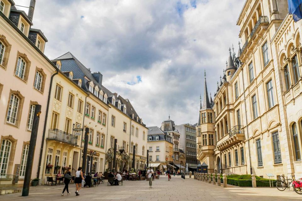 View of the Rue du Marche-aux-Herbes with the main facade of the Grand Ducal Palace on the right