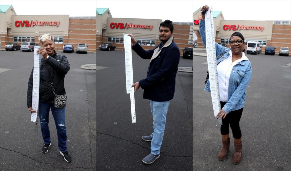 From left, Vikki Jackson, 59, Suneth Jayawardana, 29, and Stacie Jackson, 52, all from Detroit stand in front of the CVS Pharmacy on West Warren in Detroit Dec. 24, 2019, with their long receipts from the store. Jackson's receipt was 41 inches long, Jayawardana's receipt was 33 1/2 inches and Jackson's receipt was 44 inches.