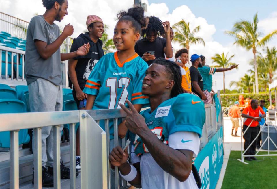 Miami Dolphins cornerback Cam Smith (24) takes a picture with a fan after NFL football training camp at Baptist Health Training Complex in Hard Rock Stadium on Thursday, August 3, 2023 in Miami Gardens, Florida.