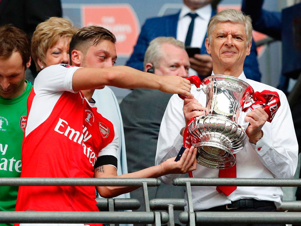 Arsene Wenger celebrates with the FA Cup trophy: Getty