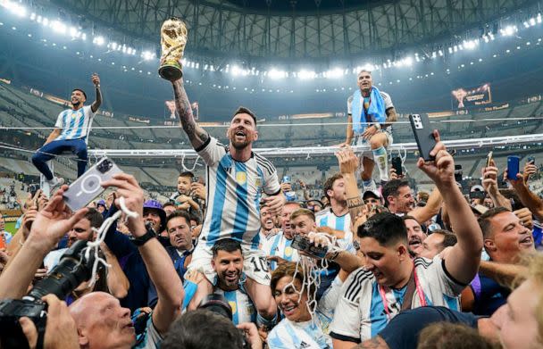 PHOTO: Argentina's Lionel Messi holds up the World Cup trophy after defeating France to win the final match of the FIFA World Cup 2022, in Lusail, Qatar. (The Washington Post via Getty Im)