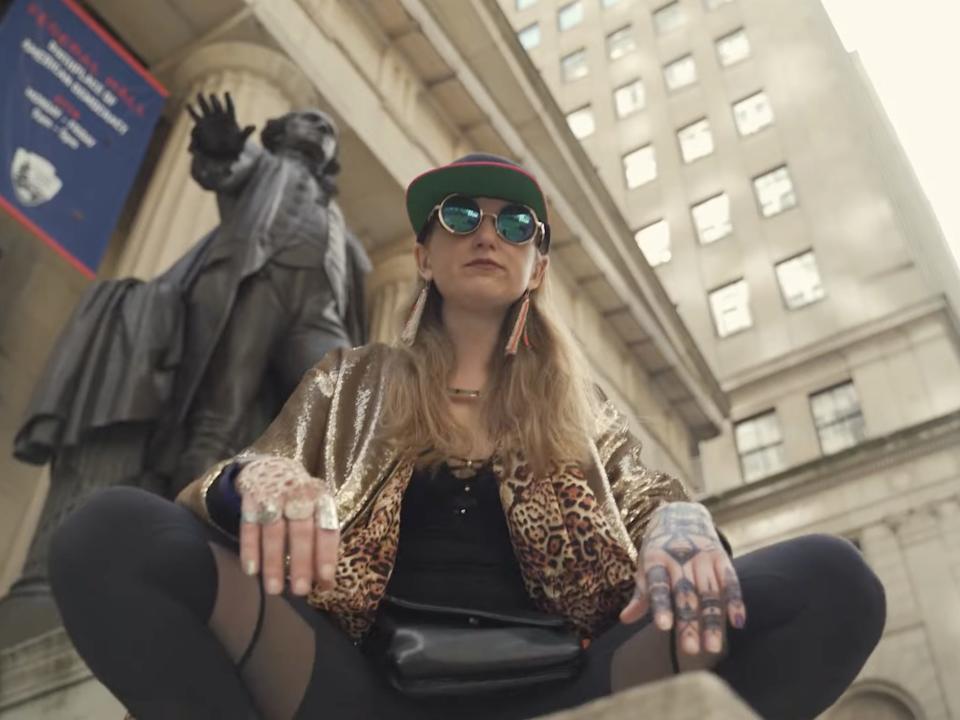 Heather Morgan sits on a pedestal in Wall Street