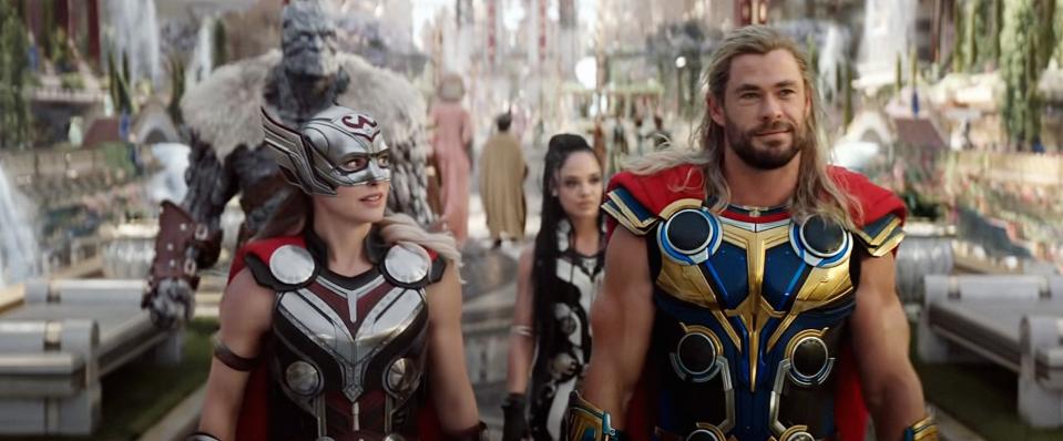 Mighty Thor and Thor in armor walking confidently with Valkyrie and Korg behind in "Thor: Love and Thunder."