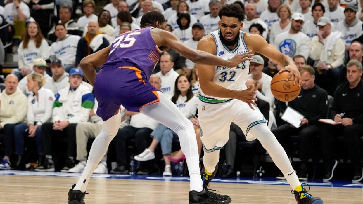 <div>Karl-Anthony Towns #32 of the Minnesota Timberwolves dribbles the ball against Kevin Durant #35 of the Phoenix Suns during the first quarter in game one of the Western Conference First Round Playoffs at Target Center on April 20, 2024 in Minneapolis, Minnesota.</div> <strong>((Photo by Patrick McDermott/Getty Images))</strong>