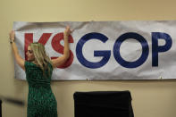 Shannon Golden prepares the stage for a GOP senatorial debate in Manhattan, Kan., Saturday, May 23, 2020. (AP Photo/Orlin Wagner)