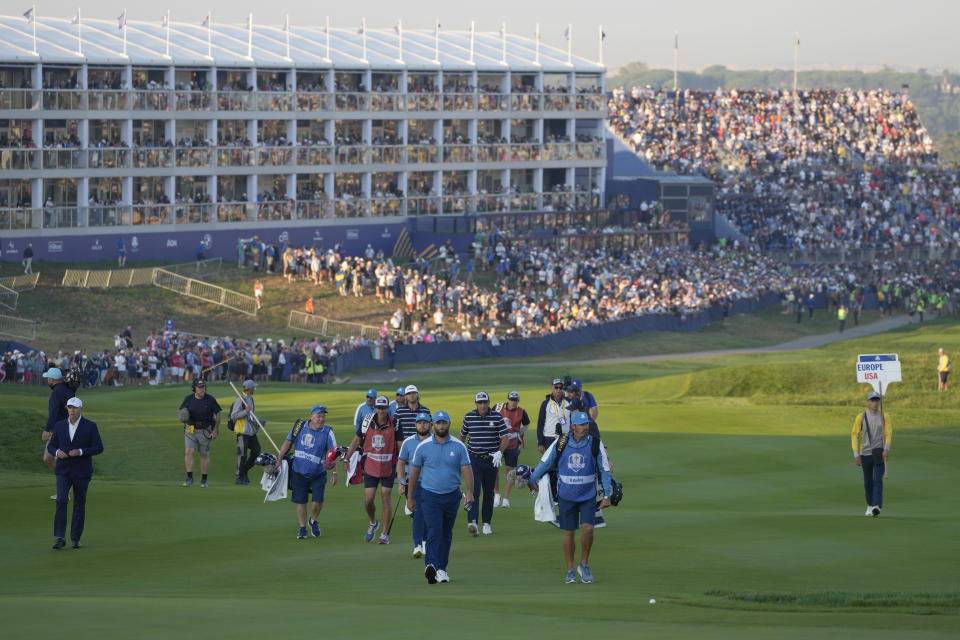 Europe's Jon Rahm, centre, walks up to the 1st green during his morning Foursome match at the Ryder Cup golf tournament at the Marco Simone Golf Club in Guidonia Montecelio, Italy, Friday, Sept. 29, 2023. (AP Photo/Alessandra Tarantino)