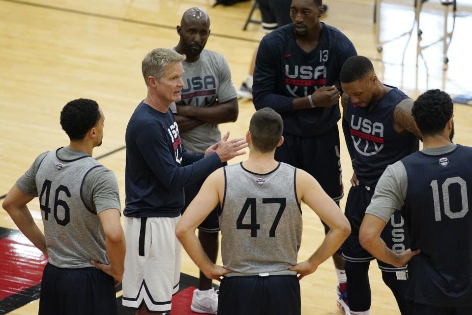 FILE - Assistant coach Steve Kerr, second from left, speaks with players during training for USA Basketball, Tuesday, July 6, 2021, in Las Vegas. Let the recruiting begin. The braintrust for the U.S. — managing director Grant Hill, national team director Sean Ford and coach Steve Kerr — is already well into the process of trying to get players thinking about wearing the red, white and blue at the World Cup in 2023 as well as the Paris Olympics in 2024. (AP Photo/John Locher, File)