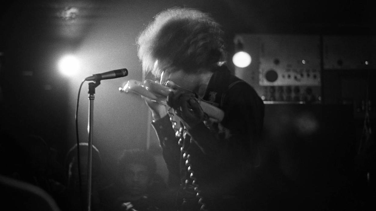  Jimi Hendrix performing live onstage at The Speakeasy in Margaret Street London W1, playing guitar with teeth . 