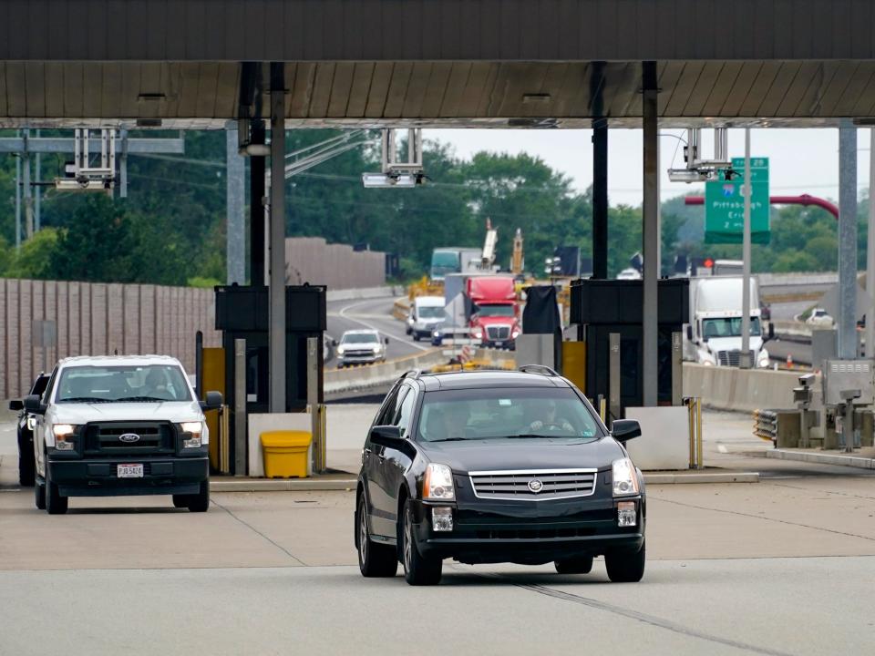 Traffic going eastbound on the Pennsylvania Turnpike proceeds through the electronic toll booths